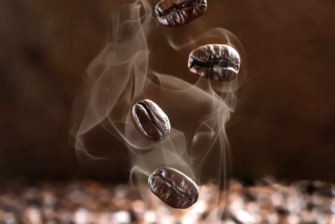 Close-up of falling steaming coffee beans