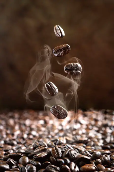 Close-up of falling steaming coffee beans
