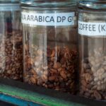 coffee beans in clear jars with labels. arabica and luwak coffee