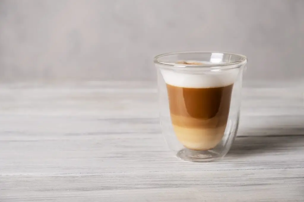 Coffee latte or cappuccino in glass with double heat-resistant walls