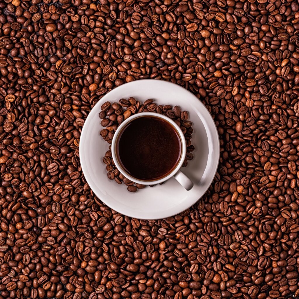 Cup of coffee on a background of coffee beans