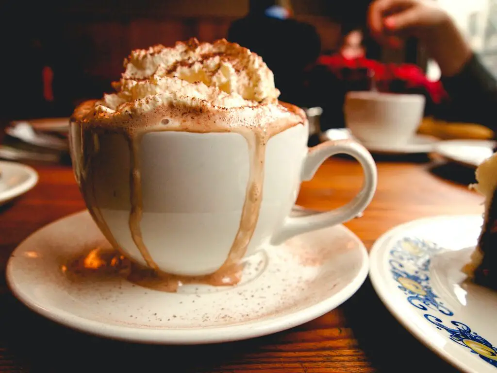 Cup of mochaccino served with delicious cream on the top