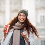 Woman drinking coffee in the streets of Madrid on winter