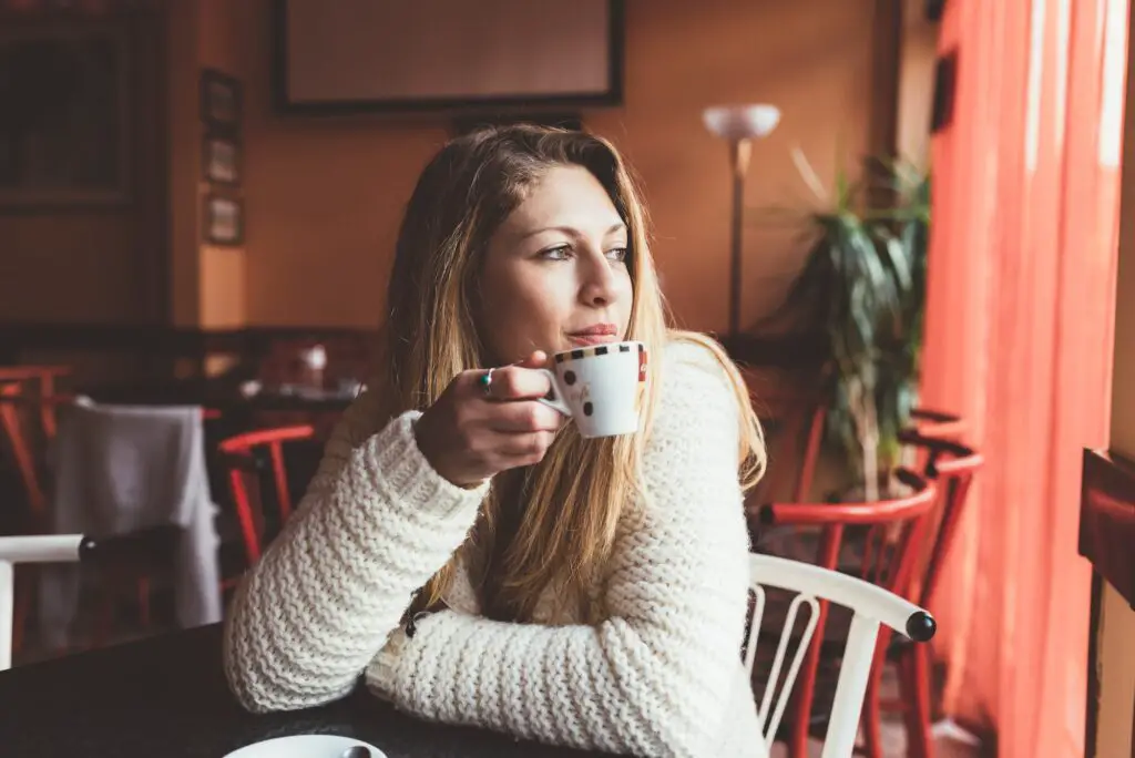 Young woman drinking coffee bar