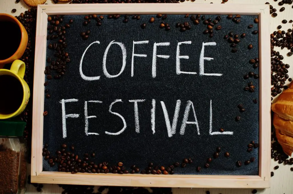 Coffee festival. Words on blackboard flat lay.