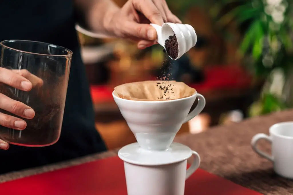 Filter Coffee. Pouring Ground Coffee into Manual Lard Coffee Mak