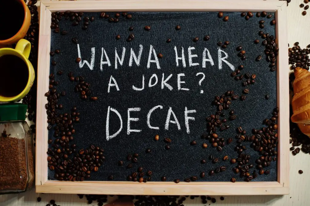 Wanna hear a joke? Decaf. Words on blackboard flat lay. decaf coffee