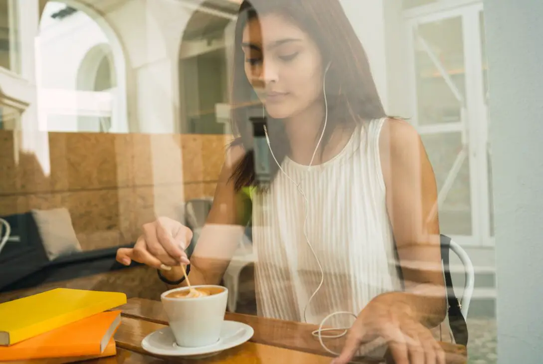 Young woman drinking a cup of coffee at coffee shop.